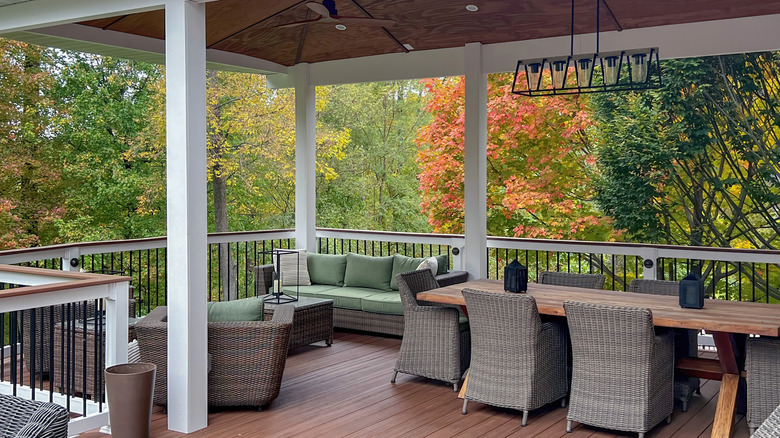Open porch with tables, chairs, and couches