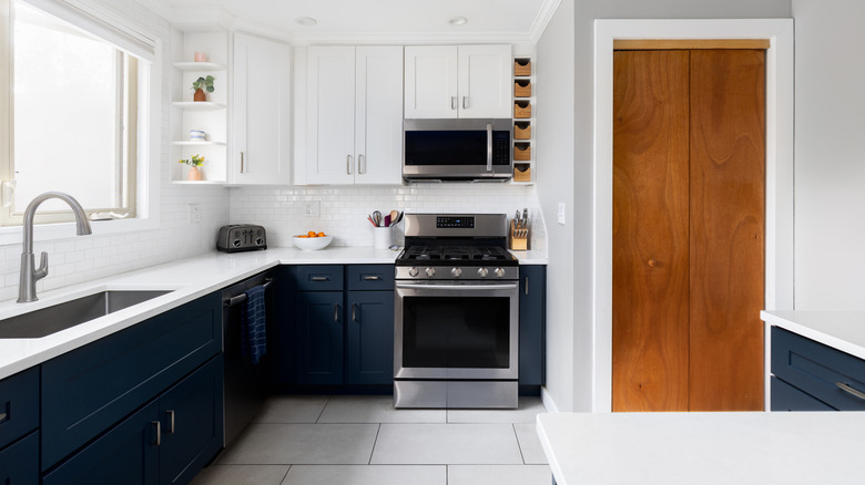 kitchen with blue cabinets and large format flooring
