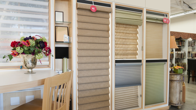 Various window blind choices in different colors and styles displayed in showroom
