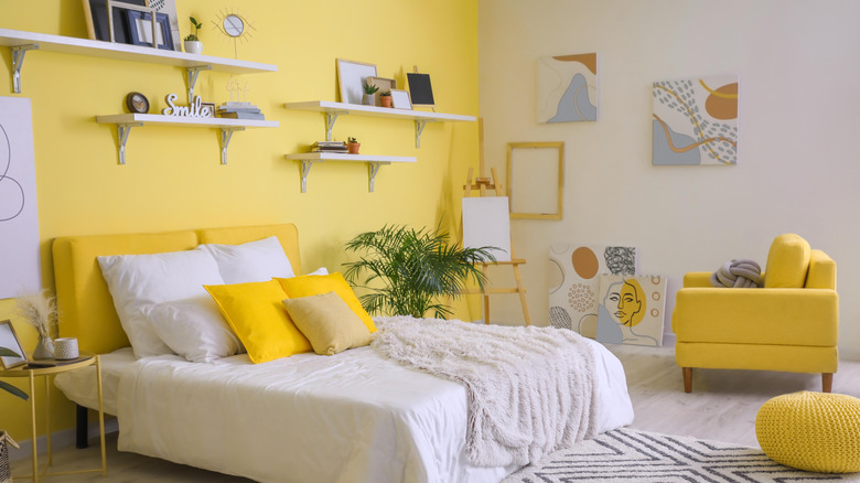 yellow accent wall in bedroom