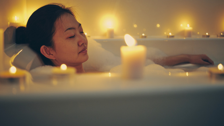 Woman enjoying candlelit bath