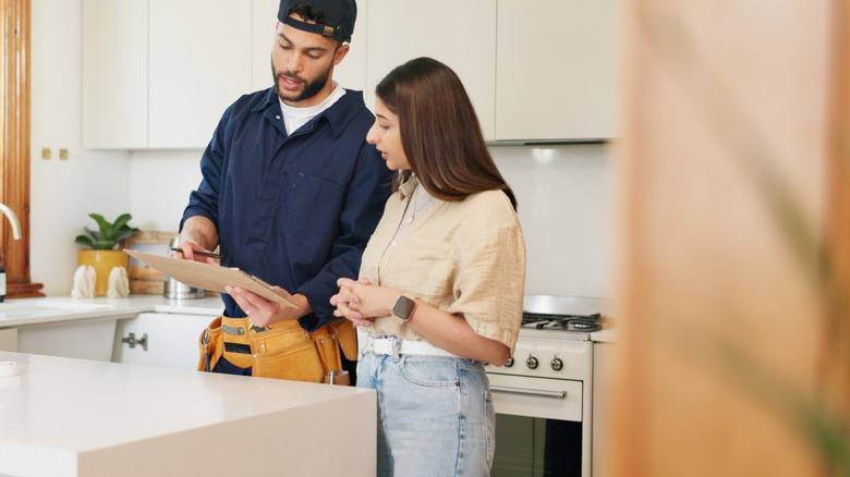 Woman and contractor going through a list