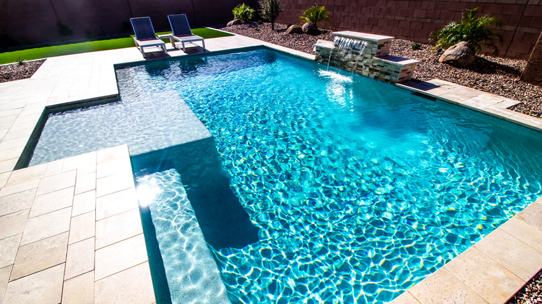 Blue-green pool in backyard