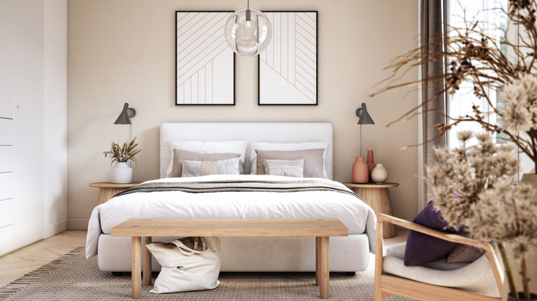 Two pieces of art hanging above someone's bed