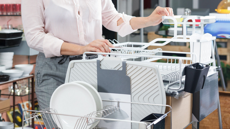 Someone shopping for dish racks at a retail store