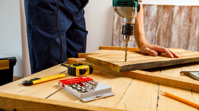 Person drilling wood