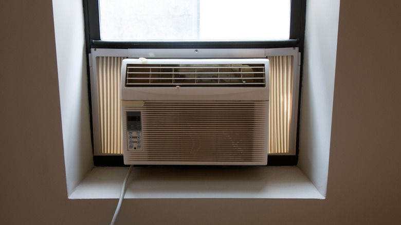 A window air conditioning unit seen from the inside of a house
