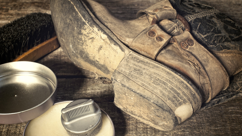A worn pair of cowboy boots about to be conditioned