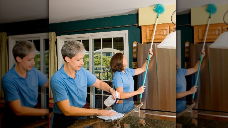 woman cleaning counter and ceiling