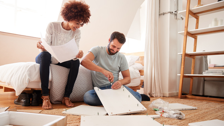 Couple assembling furniture