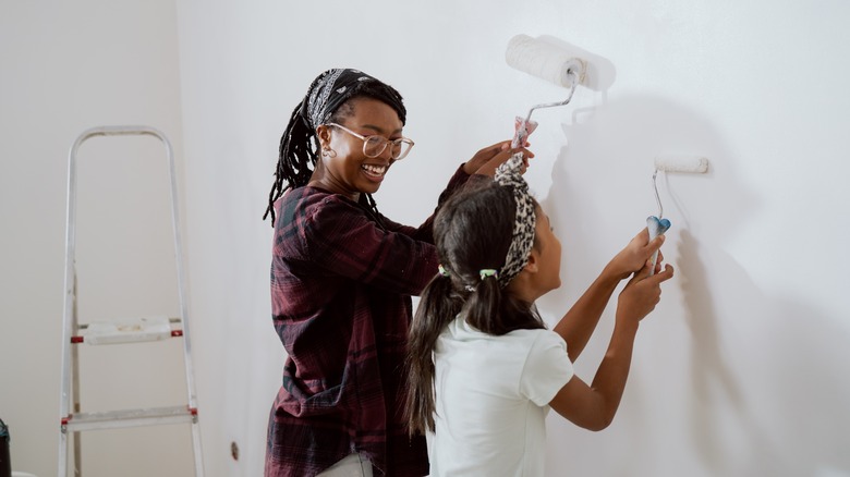 Women painting wall