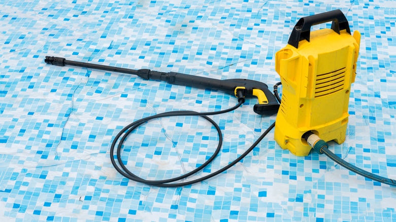 Pressure washer on pool floor