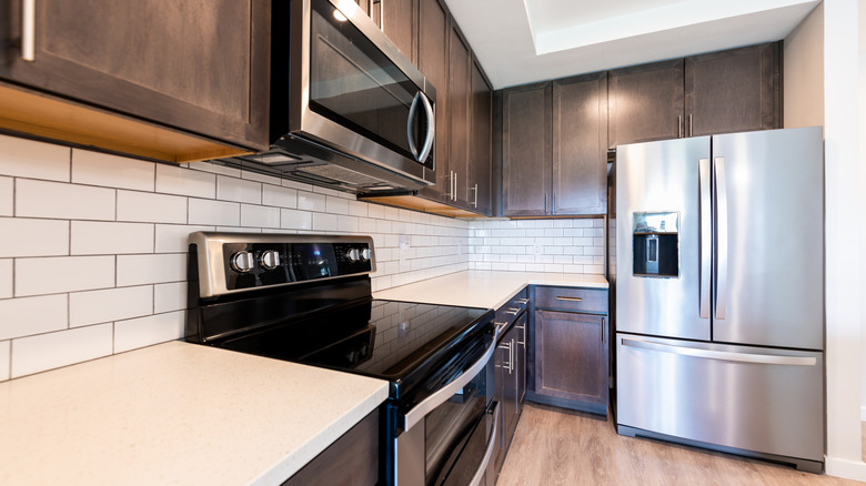 A clean kitchen with a large refrigerator and oven