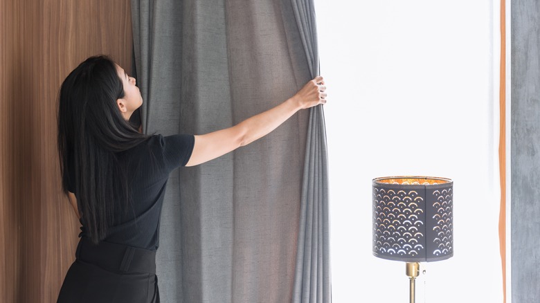 Woman draws windows closed