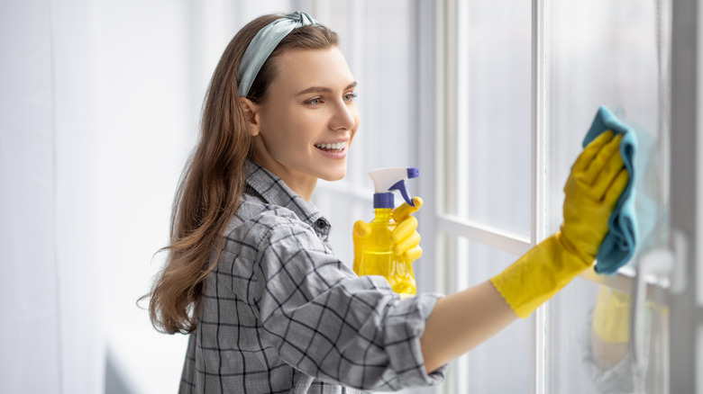 Woman cleaning window
