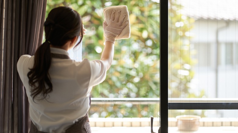Woman cleaning window