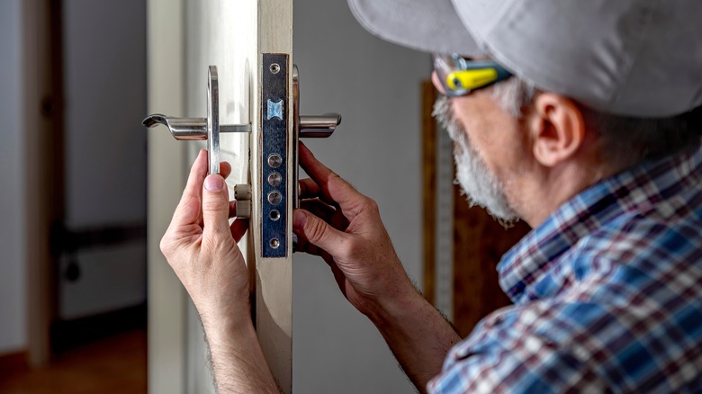 man fixing lock