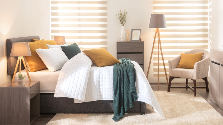A Scandi-style bedroom with zebra blinds over the windows