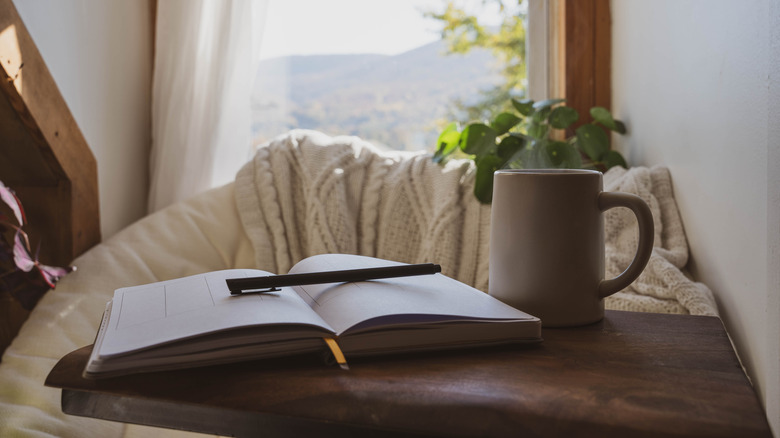 journal and cup on table