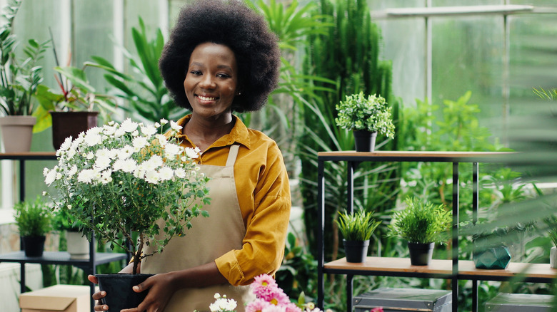 Woman tending balcony garden