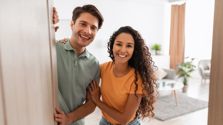 man and woman greeting guests