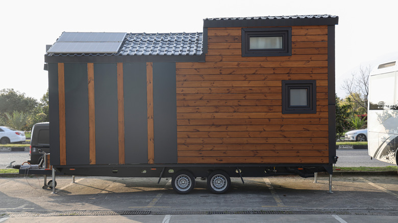 A mobile tiny home with solar panels on the roof