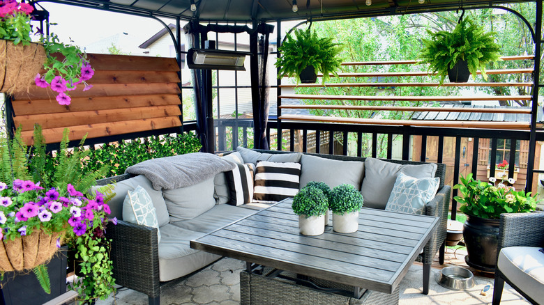 A patio living area with hanging plants