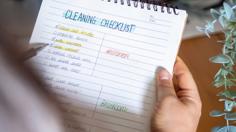 woman with cleaning checklist