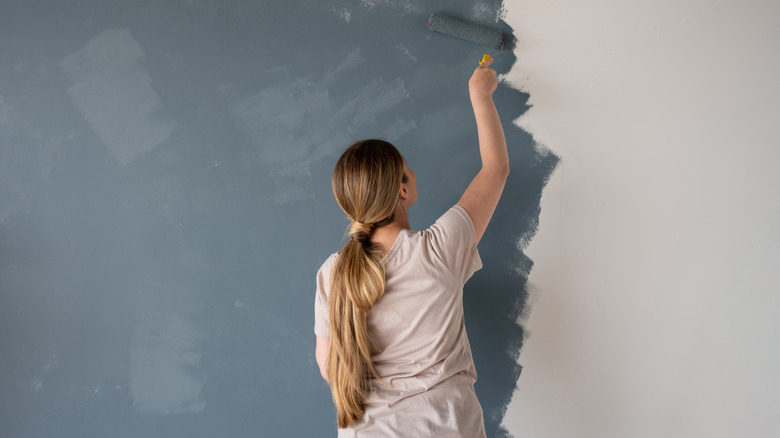 woman painting wall