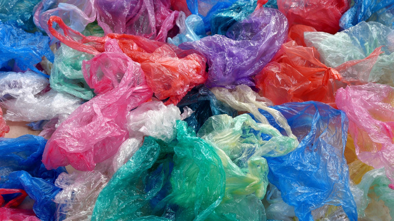 A messy pile of colored plastic grocery bags