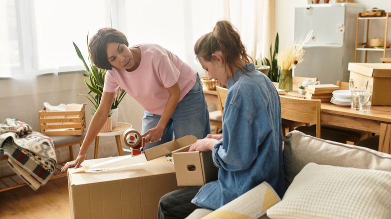 Two women decluttering together in a living space
