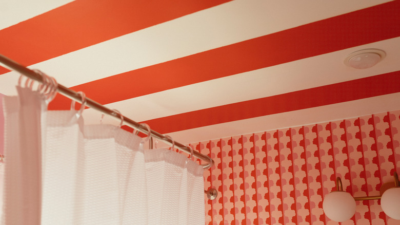 bathroom with red and white striped ceiling