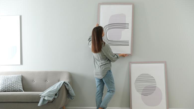 hanging art behind the couch