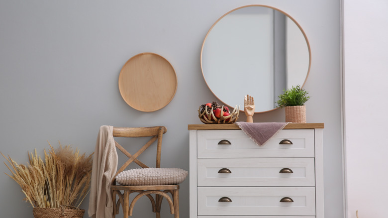 white dresser with round mirror