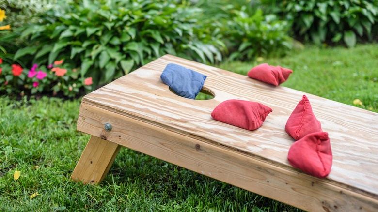 cornhole game board in yard