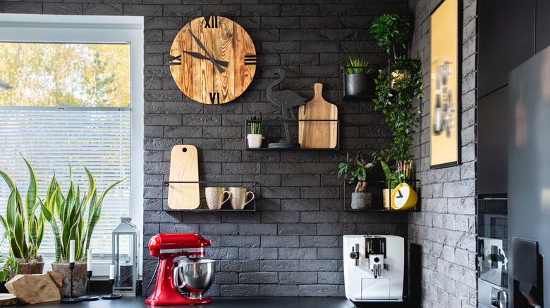 wood clock on brick wall