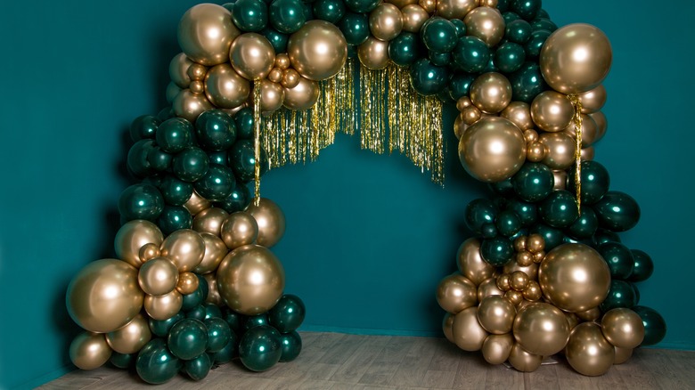 green and gold balloon arch
