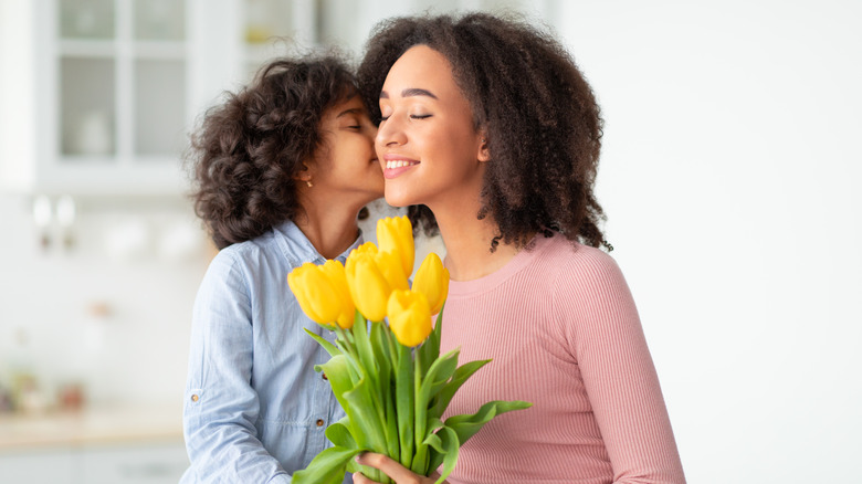 mom and child with yellow flowers