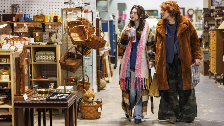 Two shoppers looking at homewares in a secondhand store