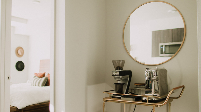 round mirror above bar cart