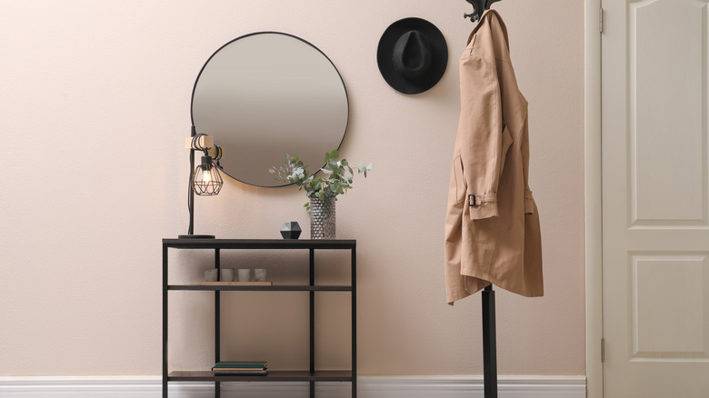circular mirror above entryway table