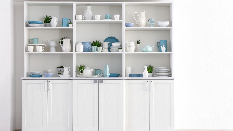 pottery grouped on shelves