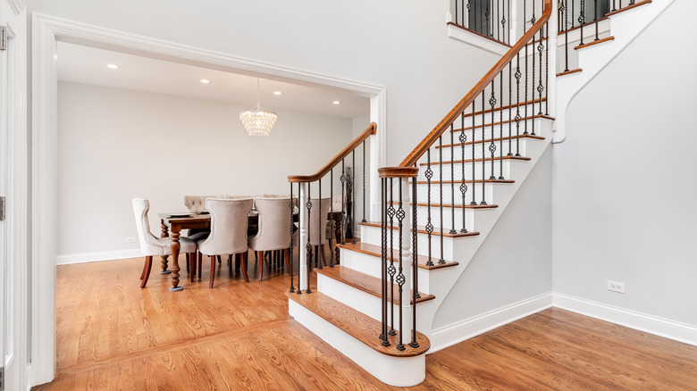 modern décor sits behind wrought-iron staircase balusters