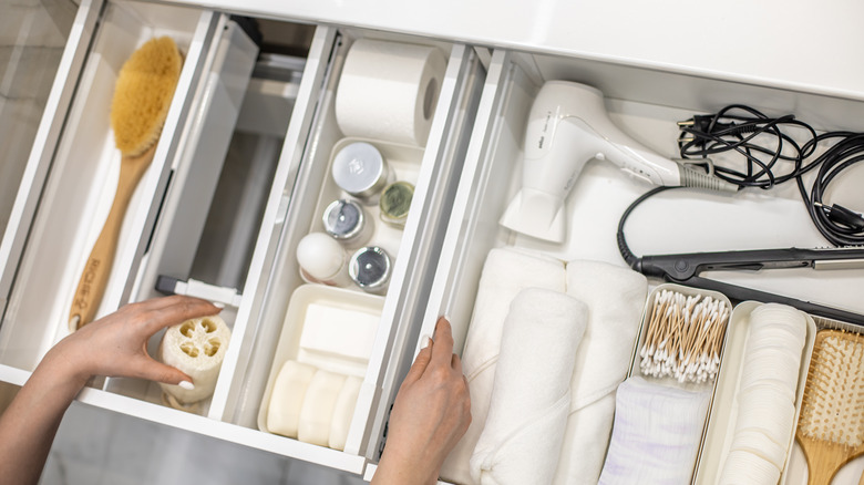 organized bathroom drawer with brush
