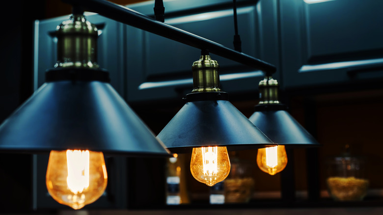 lighting fixture with dark cabinets