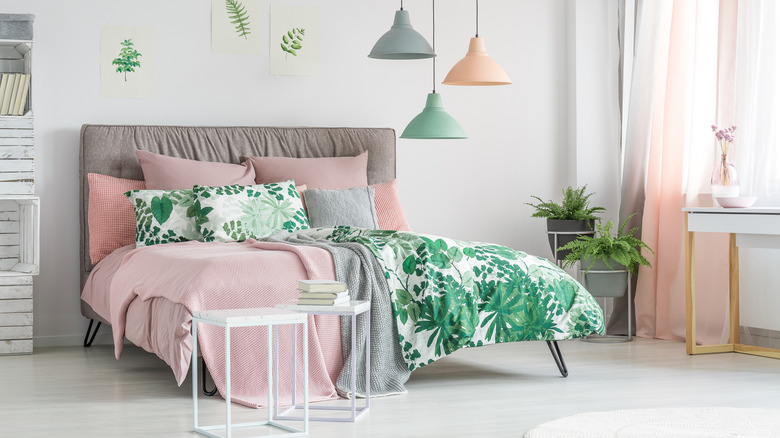 bed with botanical-patterned sheets