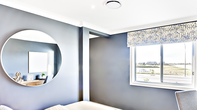 Large mirror beside a window