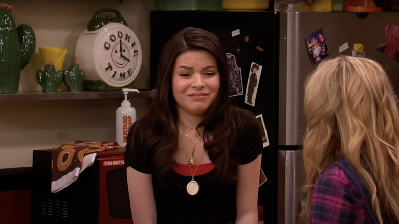 Carly next to clock in kitchen
