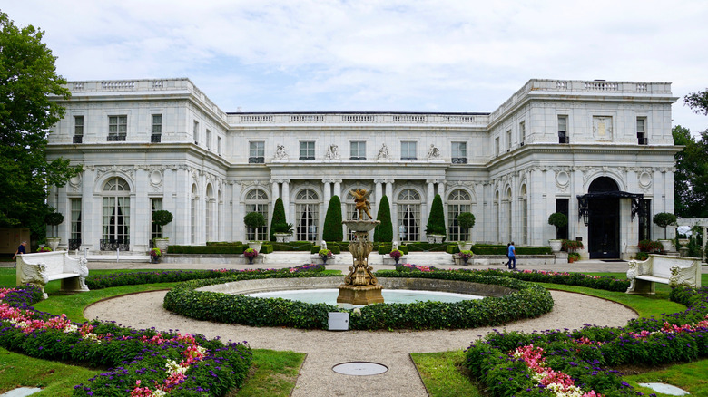 huge white mansion and fountain