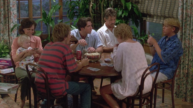 family playing cards around table